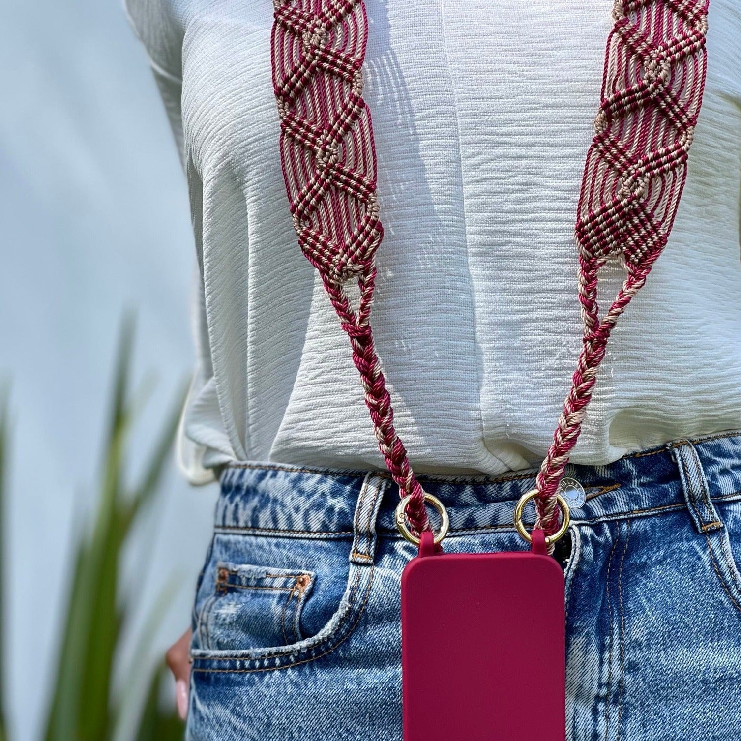 red and beige phone and bag strap